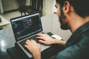 man-programming-using-laptop