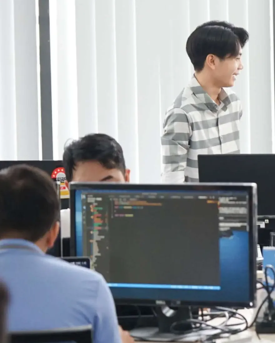 InApps engineers at their desks in the Ho Chi Minh City office, code on a monitor